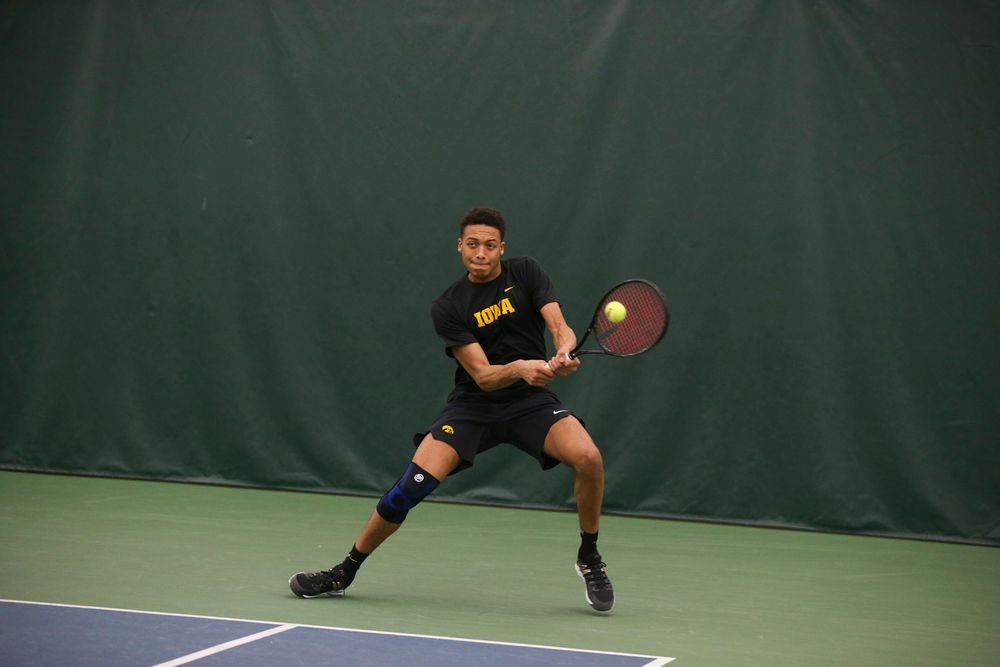 Iowa’s Oliver Okonkwo returns a ball during the Iowa men’s tennis meet vs VCU  on Saturday, February 29, 2020 at the Hawkeye Tennis and Recreation Complex. (Lily Smith/hawkeyesports.com)