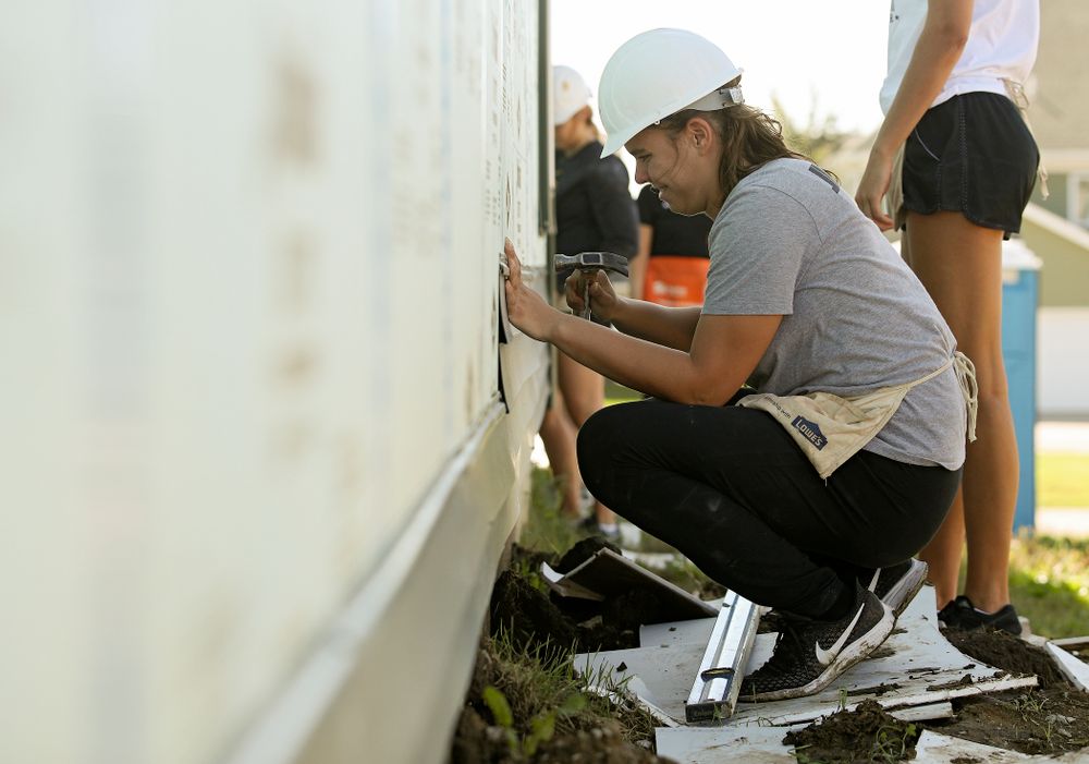 Iowa’s Paula Valino Ramos hammers in a nail on a piece of siding as they work on a Habitat for Humanity Women Build project in Iowa City on Wednesday, Sep 25, 2019. (Stephen Mally/hawkeyesports.com)