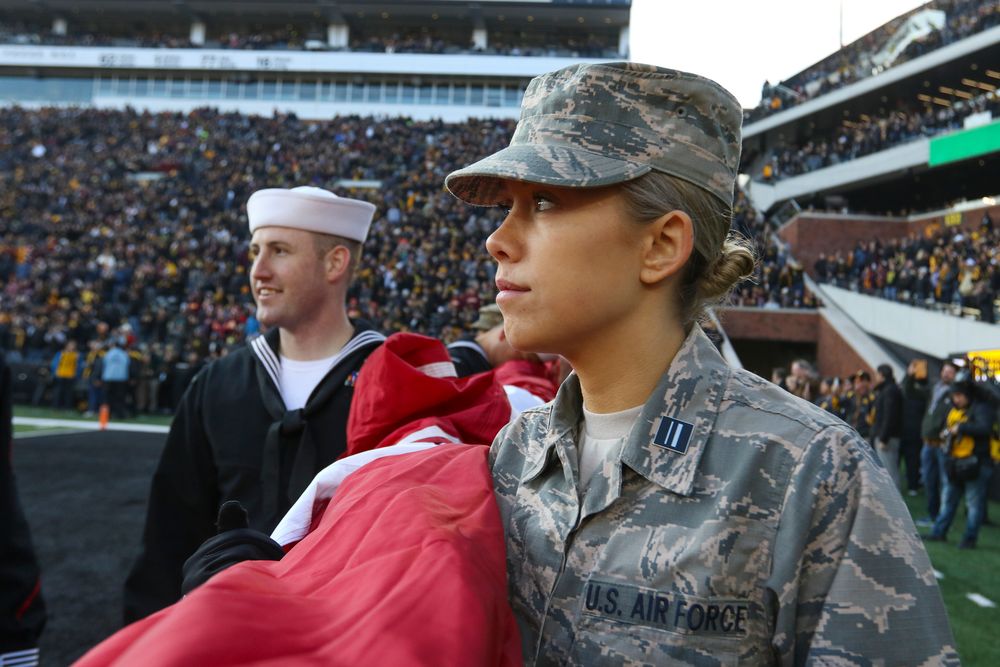 A member of the U.S. Air Force holds an American flag during Iowa football vs Minnesota on Saturday, November 16, 2019 at Kinnick Stadium. (Lily Smith/hawkeyesports.com)