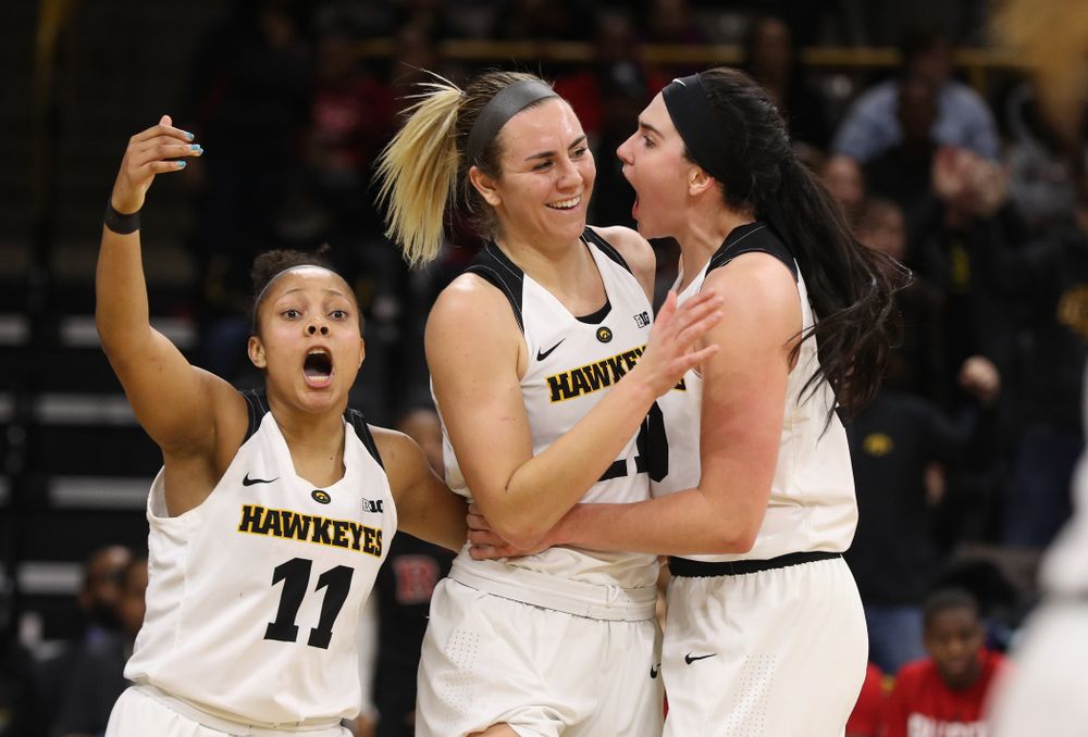 Iowa Hawkeyes forward Hannah Stewart (21) celebrates with forward Megan Gustafson (10) and guard Tania Davis (11) after getting a block and a steal late in the game against the Rutgers Scarlet Knights Wednesday, January 23, 2019 at Carver-Hawkeye Arena. (Brian Ray/hawkeyesports.com)
