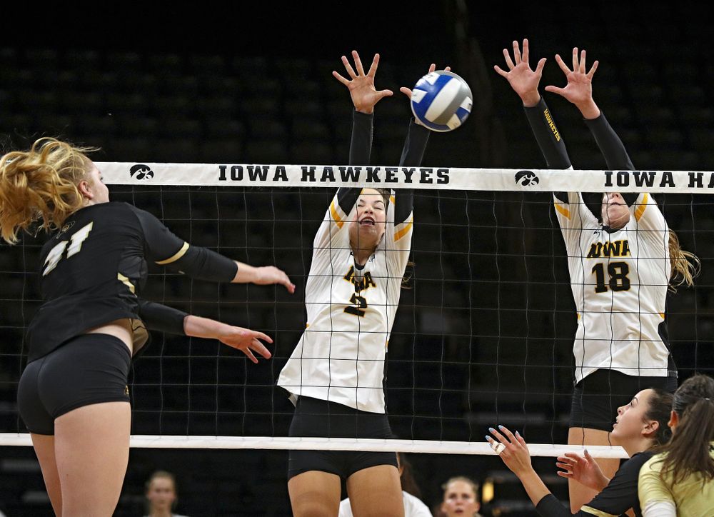 Iowa’s Courtney Buzzerio (2) and Hannah Clayton (18) try for a block during the third set of their Big Ten/Pac-12 Challenge match against Colorado at Carver-Hawkeye Arena in Iowa City on Friday, Sep 6, 2019. (Stephen Mally/hawkeyesports.com)