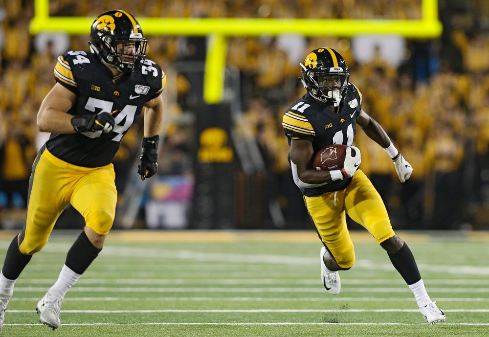 Iowa Hawkeyes defensive back Michael Ojemudia (11) runs after intercepting a pass as linebacker Kristian Welch (34) looks to block during the fourth quarter of their game at Kinnick Stadium in Iowa City on Saturday, Aug 31, 2019. (Stephen Mally/hawkeyesports.com)