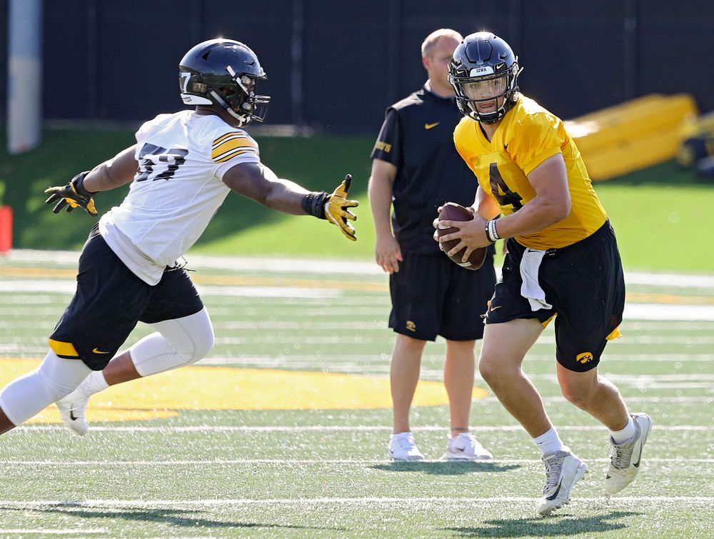 Iowa Hawkeyes quarterback Nate Stanley (4) steps up to avoid defensive end Chauncey Golston (57) during Fall Camp Practice No. 13 at the Hansen Football Performance Center in Iowa City on Friday, Aug 16, 2019. (Stephen Mally/hawkeyesports.com)