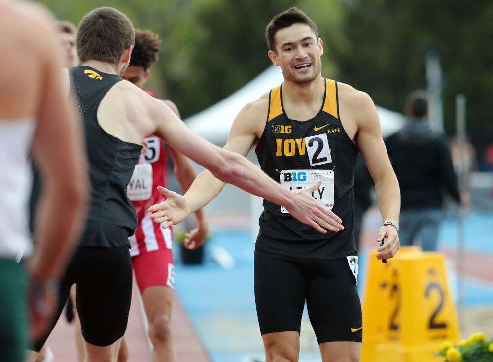 Iowa's Nolan Teubel (from left) slaps hands with Carter Lilly after running the men’s 800 meter event on the second day of the Big Ten Outdoor Track and Field Championships at Francis X. Cretzmeyer Track in Iowa City on Saturday, May. 11, 2019. (Stephen Mally/hawkeyesports.com)