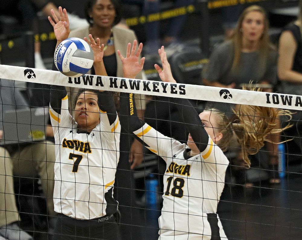 Iowa’s Brie Orr (7) gets her hands on a shot as Hannah Clayton (18) looks on during the first set of their volleyball match at Carver-Hawkeye Arena in Iowa City on Sunday, Oct 13, 2019. (Stephen Mally/hawkeyesports.com)