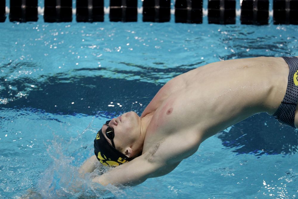 IowaÕs Ryan Purdy competes in the 100 yard backstroke against Notre Dame and Illinois Saturday, January 11, 2020 at the Campus Recreation and Wellness Center.  (Brian Ray/hawkeyesports.com)