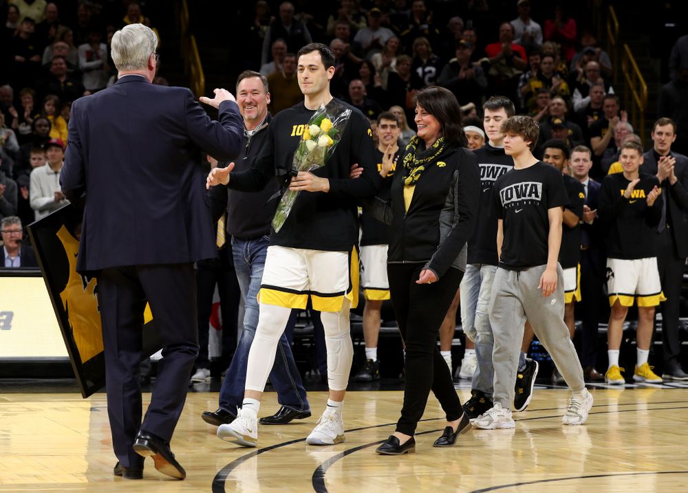 Iowa Hawkeyes forward Ryan Kriener (15) hold up his jersey during senior night activities before their game against the Purdue Boilermakers Tuesday, March 3, 2020 at Carver-Hawkeye Arena. (Brian Ray/hawkeyesports.com)