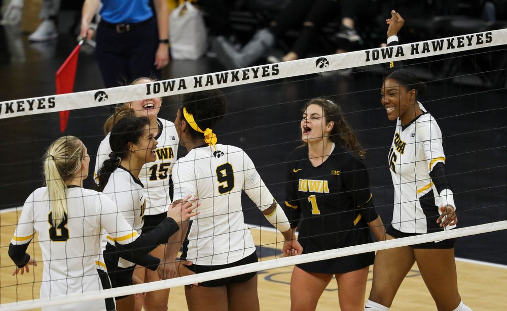 Iowa Hawkeyes setter Brie Orr (7), Iowa Hawkeyes defensive specialist Molly Kelly (1) and Iowa Hawkeyes outside hitter Taylor Louis (16) celebrate after winning a point during a match against Rutgers at Carver-Hawkeye Arena on November 2, 2018. (Tork Mason/hawkeyesports.com)