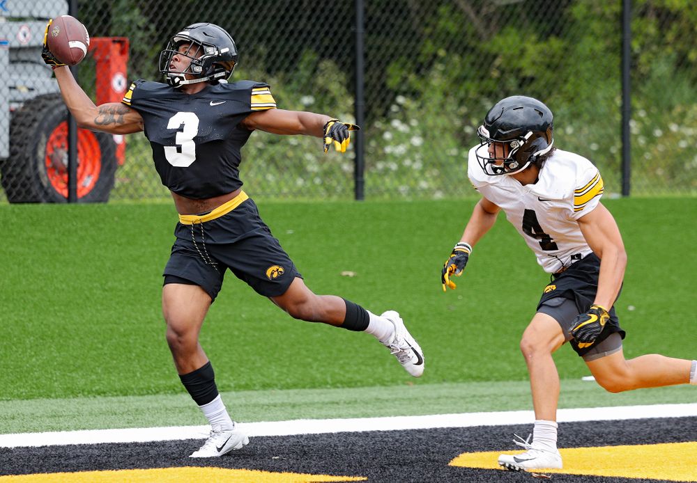 Iowa Hawkeyes wide receiver Tyrone Tracy Jr. (3) snags a pass as defensive back Dane Belton (4) closes in during Fall Camp Practice No. 15 at the Hansen Football Performance Center in Iowa City on Monday, Aug 19, 2019. (Stephen Mally/hawkeyesports.com)