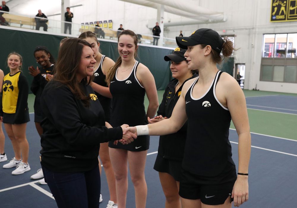 Academic Student Services Associate Director Kara Park congratulates Elise Van Heuvelen for earning a 3.0 GPA or better during the fall semester before their match against the Penn State Nittany Lions Sunday, February 24, 2019 at the Hawkeye Tennis and Recreation Complex. (Brian Ray/hawkeyesports.com)