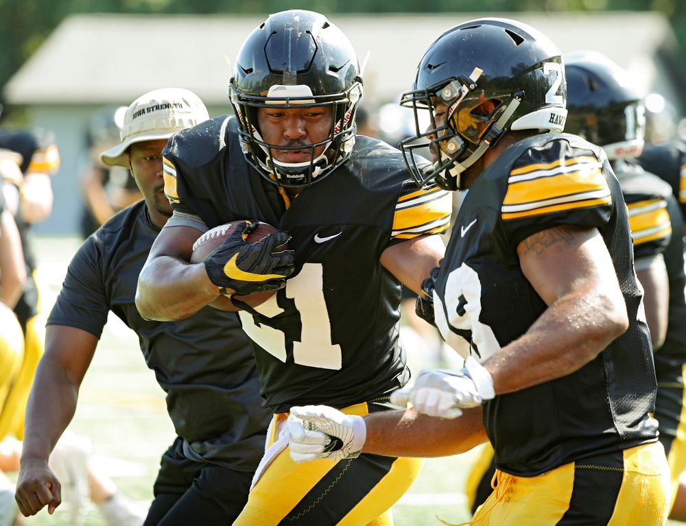 Iowa Hawkeyes running back Ivory Kelly-Martin (21) runs a drill between running backs coach Derrick Foster (left) and running back Toren Young (28) during Fall Camp Practice #5 at the Hansen Football Performance Center in Iowa City on Tuesday, Aug 6, 2019. (Stephen Mally/hawkeyesports.com)