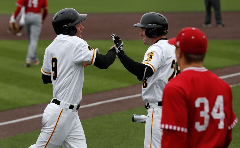 Iowa Hawkeyes outfielder Ben Norman (9) and infielder Chris Whelan (28) during a double header against the Indiana Hoosiers Friday, March 23, 2018 at Duane Banks Field. (Brian Ray/hawkeyesports.com)