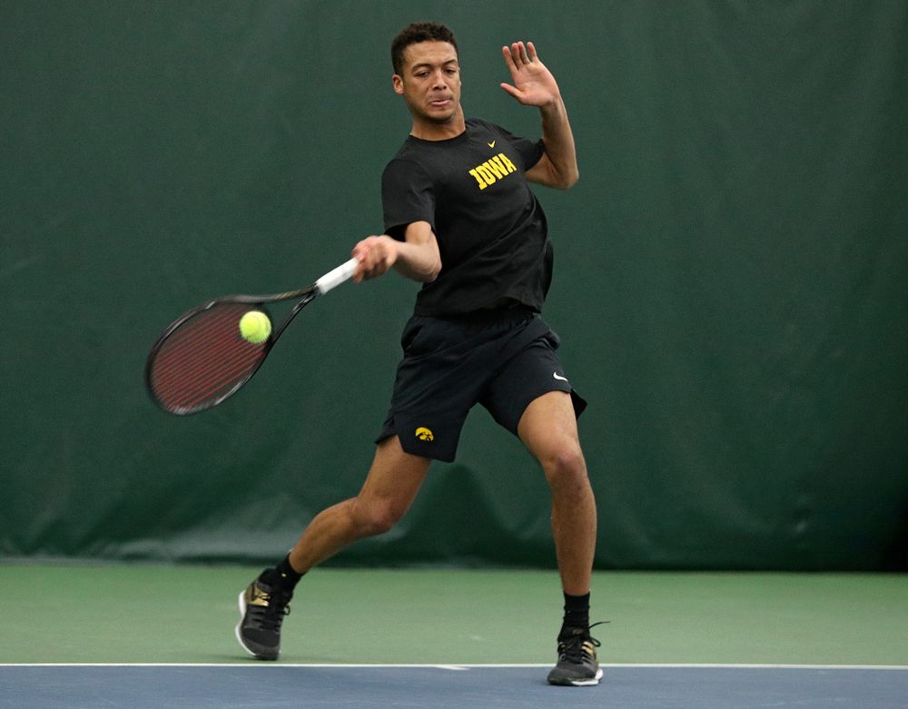 Iowa’s Oliver Okonkwo returns a shot during his singles match at the Hawkeye Tennis and Recreation Complex in Iowa City on Friday, March 6, 2020. (Stephen Mally/hawkeyesports.com)