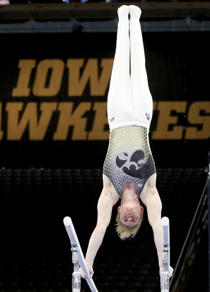 Iowa’s Nick Merryman competes on the parallel bars against Illinois Sunday, March 1, 2020 at Carver-Hawkeye Arena. (Brian Ray/hawkeyesports.com)