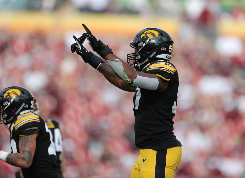 Iowa Hawkeyes defensive end Chauncey Golston (57) celebrates with defensive back Amani Hooker (27) after intercepting a pass during the Outback Bowl Tuesday, January 1, 2019 at Raymond James Stadium in Tampa, FL. (Brian Ray/hawkeyesports.com)