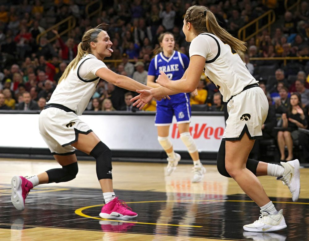 Iowa Hawkeyes guard Makenzie Meyer (3) slaps hands with guard Kathleen Doyle (22) after Doyle made a basket during the fourth quarter of their game at Carver-Hawkeye Arena in Iowa City on Saturday, December 21, 2019. (Stephen Mally/hawkeyesports.com)