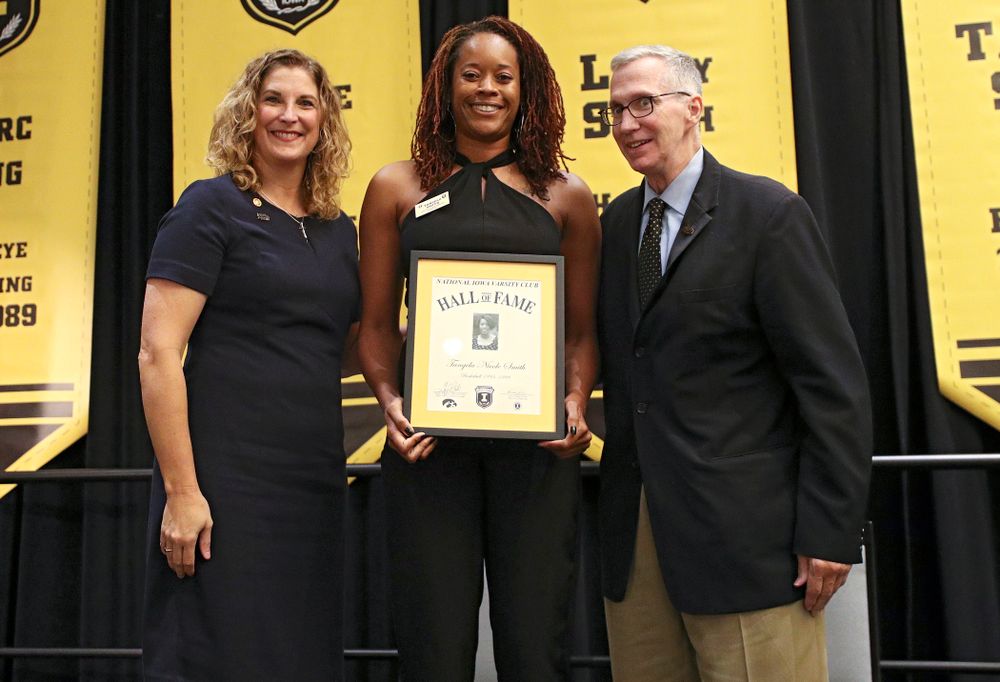 Barb Randall (from left), co-chair of the Varsity Club Advisory Committee, 2019 University of Iowa Athletics Hall of Fame inductee Tangela Smith, and Andy Piro, assistant athletics director and executive director of the Varsity Club, during the Hall of Fame Induction Ceremony at the Coralville Marriott Hotel and Conference Center in Coralville on Friday, Aug 30, 2019. (Stephen Mally/hawkeyesports.com)