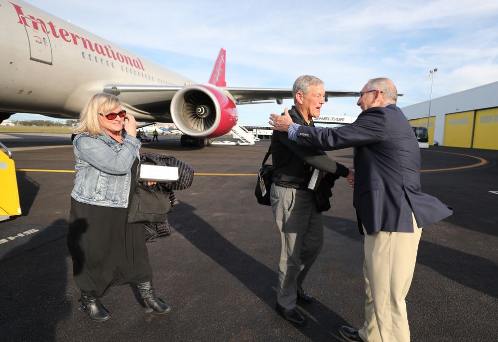 Iowa Hawkeyes head coach Kirk Ferentz shakes hands with Outback Bowl team host Bruce Poli Wednesday, December 26, 2018 as they arrive in Tampa, Florida for the Outback Bowl. (Brian Ray/hawkeyesports.com)