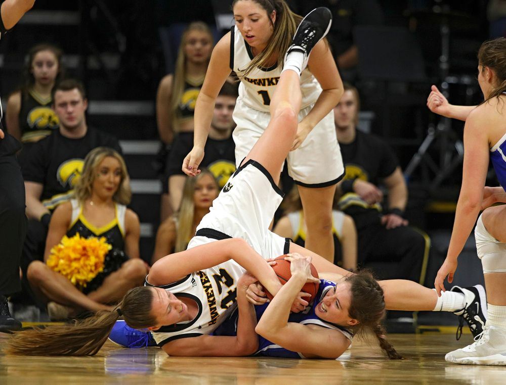 Iowa Hawkeyes forward Amanda Ollinger (43) hangs on to a tie ball during the third quarter of their game at Carver-Hawkeye Arena in Iowa City on Saturday, December 21, 2019. (Stephen Mally/hawkeyesports.com)