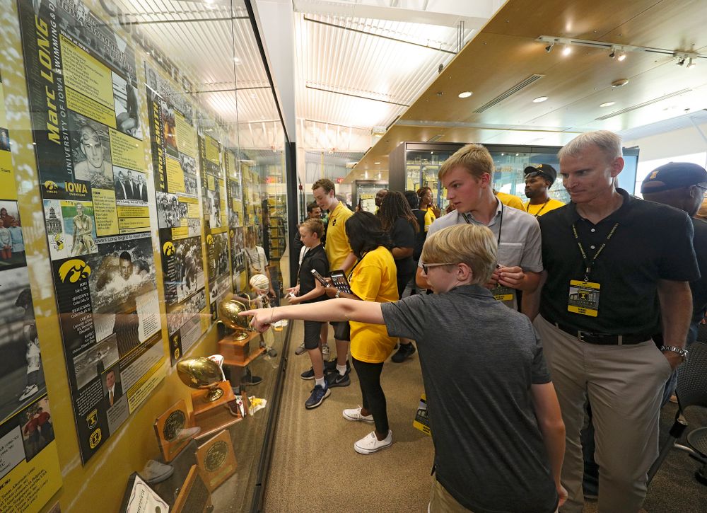 2019 University of Iowa Athletics Hall of Fame inductee Marc Long looks at his exhibit with his family after it was unveiled at the University of Iowa Athletics Hall of Fame in Iowa City on Friday, Aug 30, 2019. (Stephen Mally/hawkeyesports.com)