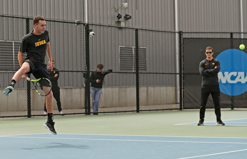 Iowa's Kareem Allaf hits a shot between his legs during a double match against Ohio State at the Hawkeye Tennis and Recreation Complex in Iowa City on Sunday, Apr. 7, 2019. (Stephen Mally/hawkeyesports.com)