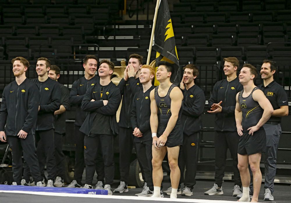 Members of the Iowa gymnastics team laugh as they watch the video board during their meet against Ohio State at Caver-Hawkeye Arena in Iowa City on Saturday, Mar. 16, 2019. (Stephen Mally for HawkeyeSports.com)