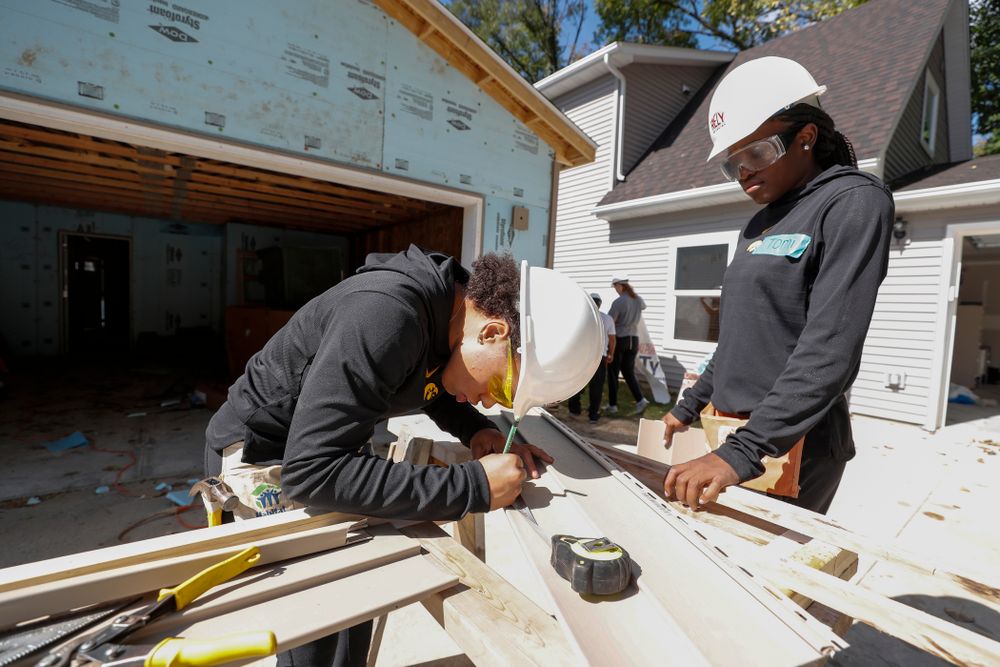 Iowa Hawkeyes guard Alexis Sevillian (5) and guard Tomi Taiwo (1) work on the Habitat for Humanity Women's Build Wednesday, September 26, 2018 in Iowa City. (Brian Ray/hawkeyesports.com)
