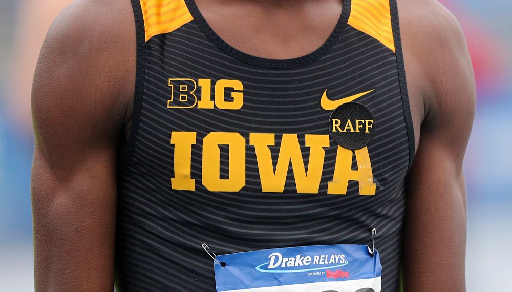 Iowa's Wayne Lawrence Jr. wears a "Raff" sticker in memory of the late Iowa volunteer assistant coach John Raffensperger before the men's 1600 meter relay event during the third day of the Drake Relays at Drake Stadium in Des Moines on Saturday, Apr. 27, 2019. (Stephen Mally/hawkeyesports.com)