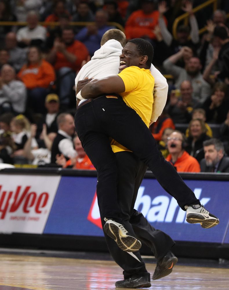 A fan celebrates after making a half court shot during the Iowa Hawkeyes game against the Illinois Fighting Illini Sunday, January 20, 2019 at Carver-Hawkeye Arena. (Brian Ray/hawkeyesports.com)