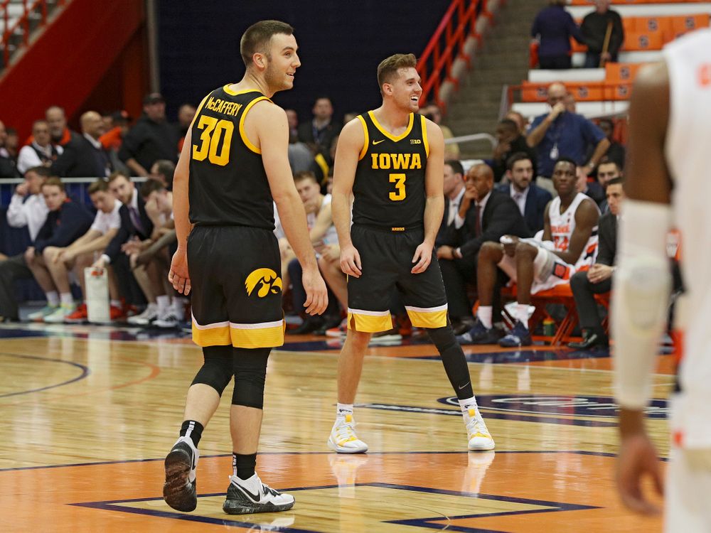 Iowa Hawkeyes guard Connor McCaffery (30) and guard Jordan Bohannon (3) are all smiles in the closing seconds of the second half of their ACC/Big Ten Challenge game at the Carrier Dome in Syracuse, N.Y. on Tuesday, Dec 3, 2019. (Stephen Mally/hawkeyesports.com)
