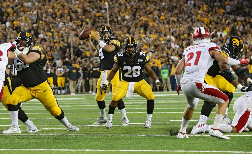 Iowa Hawkeyes quarterback Nate Stanley (4) throws a 9-yard touchdown pass during the second quarter of their game at Kinnick Stadium in Iowa City on Saturday, Aug 31, 2019. (Stephen Mally/hawkeyesports.com)