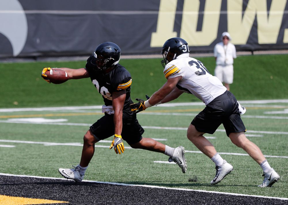 Iowa Hawkeyes running back Toren Young (28) and defensive back Jake Gervase (30) during practice No. 7 of fall camp Friday, August 10, 2018 at the Kenyon Football Practice Facility. (Brian Ray/hawkeyesports.com)