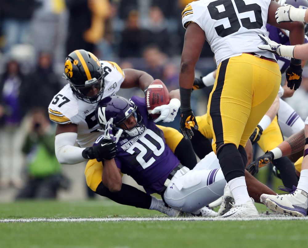 Iowa Hawkeyes defensive end Chauncey Golston (57) makes a tackle against the Northwestern Wildcats Saturday, October 26, 2019 at Ryan Field in Evanston, Ill. (Brian Ray/hawkeyesports.com)