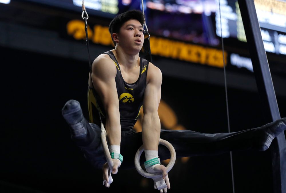 Bennet Huang competes on the rings against Illinois 