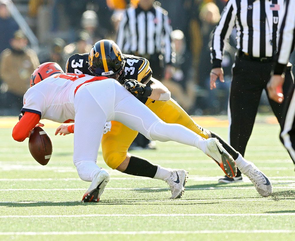 Iowa Hawkeyes linebacker Kristian Welch (34) forces Illinois Fighting Illini quarterback Brandon Peters (18) to fumble the ball during the fourth quarter of their game at Kinnick Stadium in Iowa City on Saturday, Nov 23, 2019. (Stephen Mally/hawkeyesports.com)