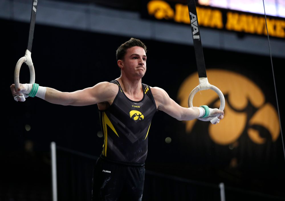 Jake Brodarzon competes on the rings against Minnesota and Air Force 