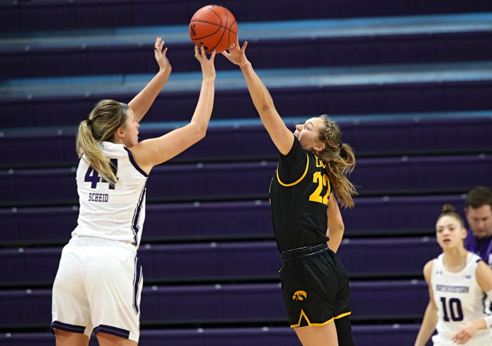 Iowa Hawkeyes guard Kathleen Doyle (22) tries to reach a shot during the first quarter of their game at Welsh-Ryan Arena in Evanston, Ill. on Sunday, January 5, 2020. (Stephen Mally/hawkeyesports.com)