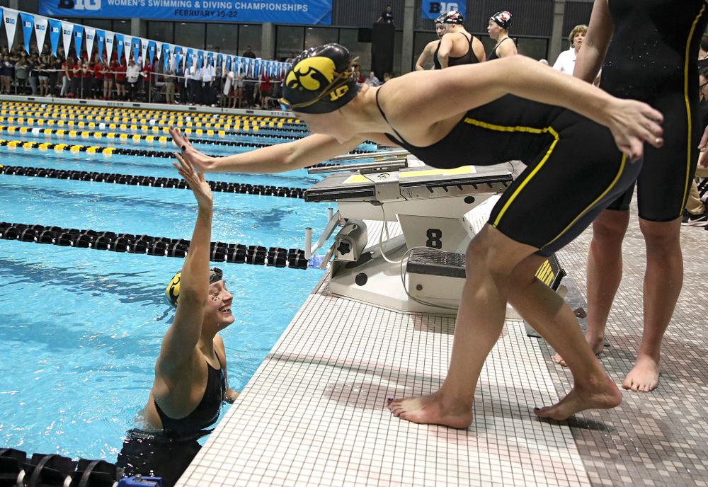 Iowa’s Hannah Burvill gets a high five after setting a school record in the women’s 400 yard medley relay event during the 2020 Women’s Big Ten Swimming and Diving Championships at the Campus Recreation and Wellness Center in Iowa City on Thursday, February 20, 2020. (Stephen Mally/hawkeyesports.com)