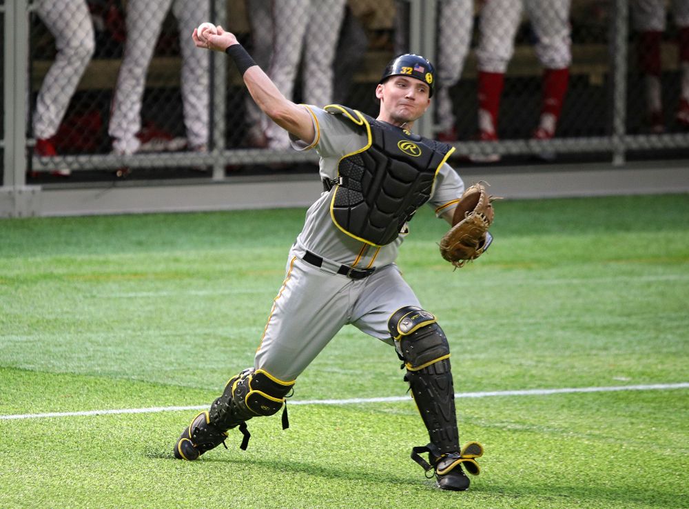 Iowa Hawkeyes catcher Brett McCleary (32) throws to first for an out during the seventh inning of their CambriaCollegeClassic game at U.S. Bank Stadium in Minneapolis, Minn. on Friday, February 28, 2020. (Stephen Mally/hawkeyesports.com)
