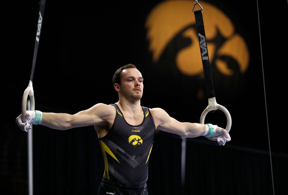 Dylan Ellsworth competes on the rings against Illinois 