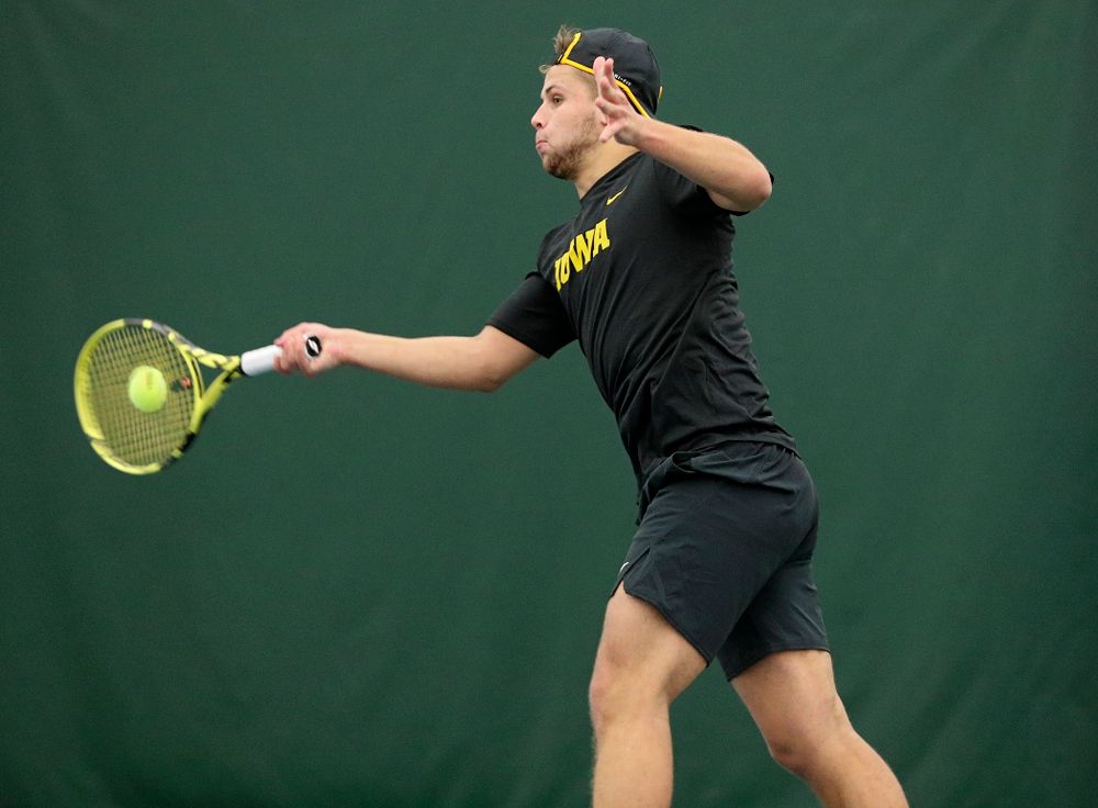 Iowa’s Will Davies returns a shot during their match at the Hawkeye Tennis and Recreation Complex in Iowa City on Thursday, January 16, 2020. (Stephen Mally/hawkeyesports.com)
