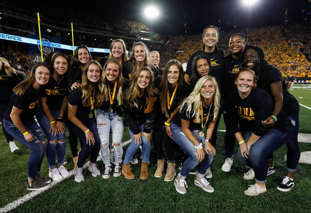 Members of the Iowa women's track and field team are recognized by the Presidential Committee on Athletics at halftime during a game against Wisconsin on September 22, 2018. (Tork Mason/hawkeyesports.com)