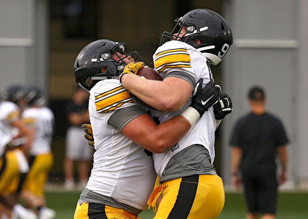 Iowa Hawkeyes defensive lineman Brady Reiff (from left) hits defensive lineman John Waggoner (92) as they run a drill durning Fall Camp Practice No. 17 at the Hansen Football Performance Center in Iowa City on Wednesday, Aug 21, 2019. (Stephen Mally/hawkeyesports.com)