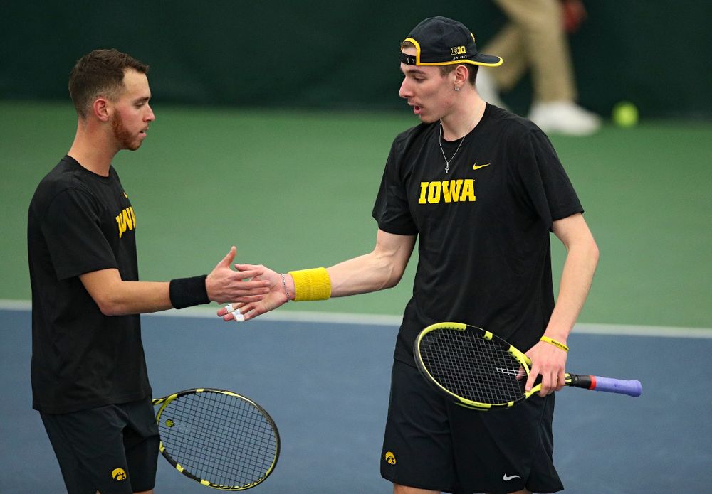 Iowa’s Kareem Allaf (from left) and Nikita Snezhko celebrate after winning their doubles match at the Hawkeye Tennis and Recreation Complex in Iowa City on Friday, March 6, 2020. (Stephen Mally/hawkeyesports.com)