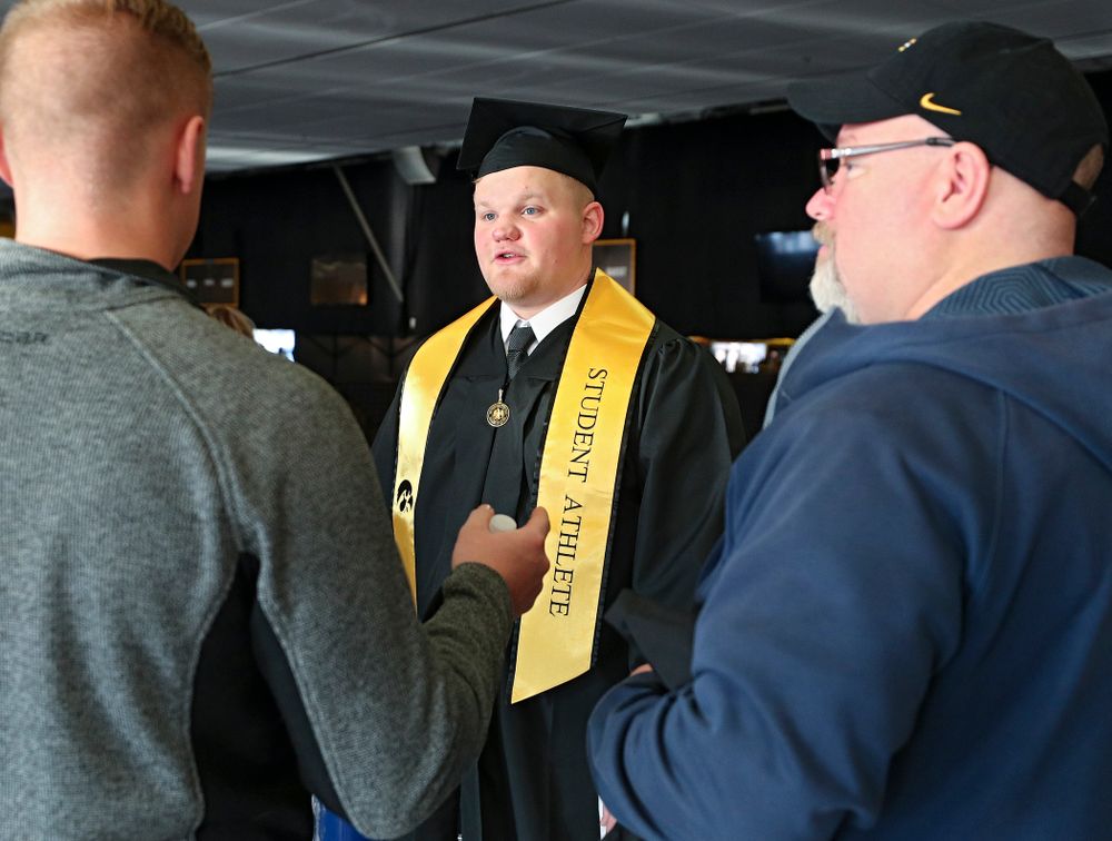 Iowa offensive lineman Spencer Williams talks on the concourse before the College of Liberal Arts and Sciences and University College Fall 2019 Commencement ceremony at Carver-Hawkeye Arena in Iowa City on Saturday, December 21, 2019. (Stephen Mally/hawkeyesports.com)