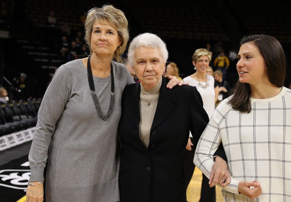 Former University of Iowa Director of Intercollegiate Athletics for Women Dr. Christine Grant receives her trophy for being inducted into the WomenÕs Basketball Hall of Fame from Iowa Hawkeyes head coach Lisa Bluder and director of basketball operations Kathryn Reynolds 
  before their game against the Robert Morris Colonials Sunday, December 2, 2018 at Carver-Hawkeye Arena. (Photo by Brian Ray)
