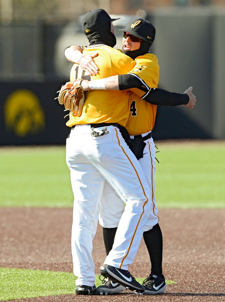 Iowa Hawkeyes shortstop Tanner Wetrich (16) and second baseman Mitchell Boe (4) celebrate after winning their game against Illinois at Duane Banks Field in Iowa City on Sunday, Mar. 31, 2019. (Stephen Mally/hawkeyesports.com)
