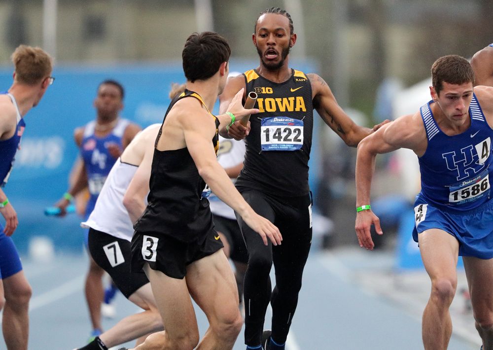 Iowa's Mar'yea Harris (right) hands off the baton to Carter Lilly as they run the men's sprint medley relay event during the third day of the Drake Relays at Drake Stadium in Des Moines on Saturday, Apr. 27, 2019. (Stephen Mally/hawkeyesports.com)