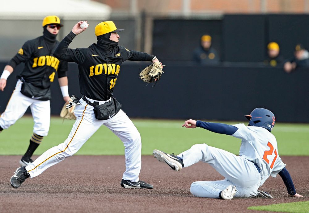 Iowa Hawkeyes shortstop Tanner Wetrich (16) throws to first base for a double play during the sixth inning of their game against Illinois at Duane Banks Field in Iowa City on Saturday, Mar. 30, 2019. (Stephen Mally/hawkeyesports.com)
