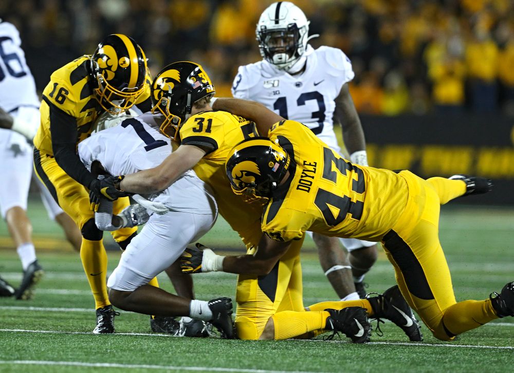 Iowa Hawkeyes defensive back Terry Roberts (16), linebacker Jack Campbell (31), and linebacker Dillon Doyle (43) bring down Penn State Nittany Lions wide receiver KJ Hamler (1) on a kickoff return during the first quarter of their game at Kinnick Stadium in Iowa City on Saturday, Oct 12, 2019. (Stephen Mally/hawkeyesports.com)